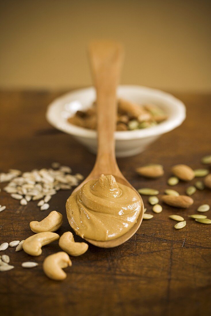 Almond Butter on Wooden Spoon; Nuts