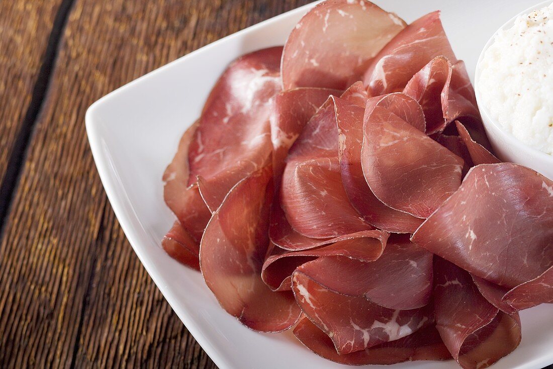 Sliced Bresaola Ham on Platter; Ricotta Cheese