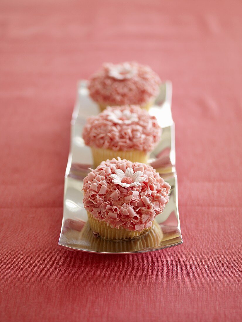 Three Pink Cupcakes with Daisy Decoration