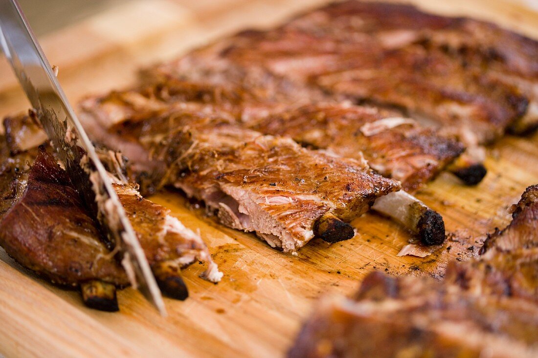 Barbecued Ribs Sliced on a Cutting Board