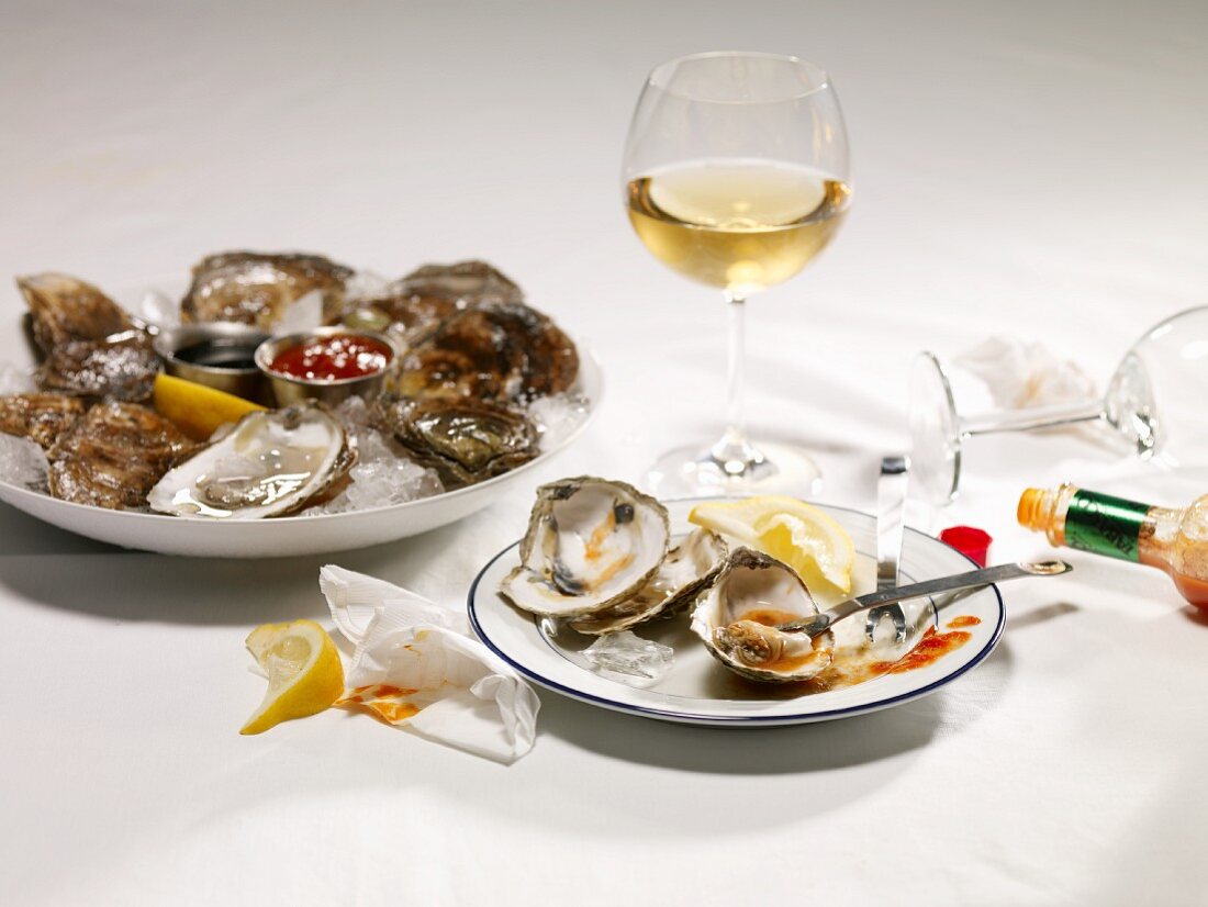 Serving Plate with Oyster Remains; Oysters on Ice; White Wine
