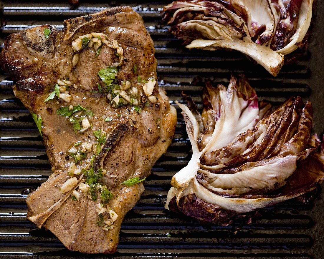 Grilled Pork Chop with Grilled Radicchio on Cast Iron Pan