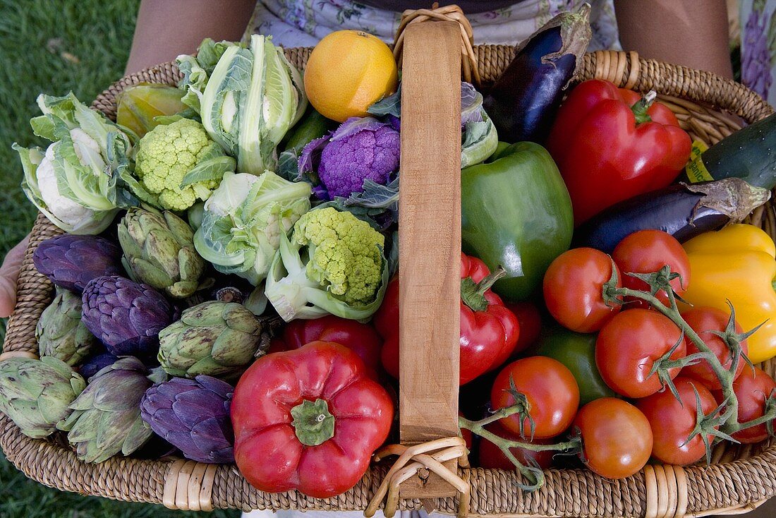 Woman Holding Large Basket of Organic Vegetables