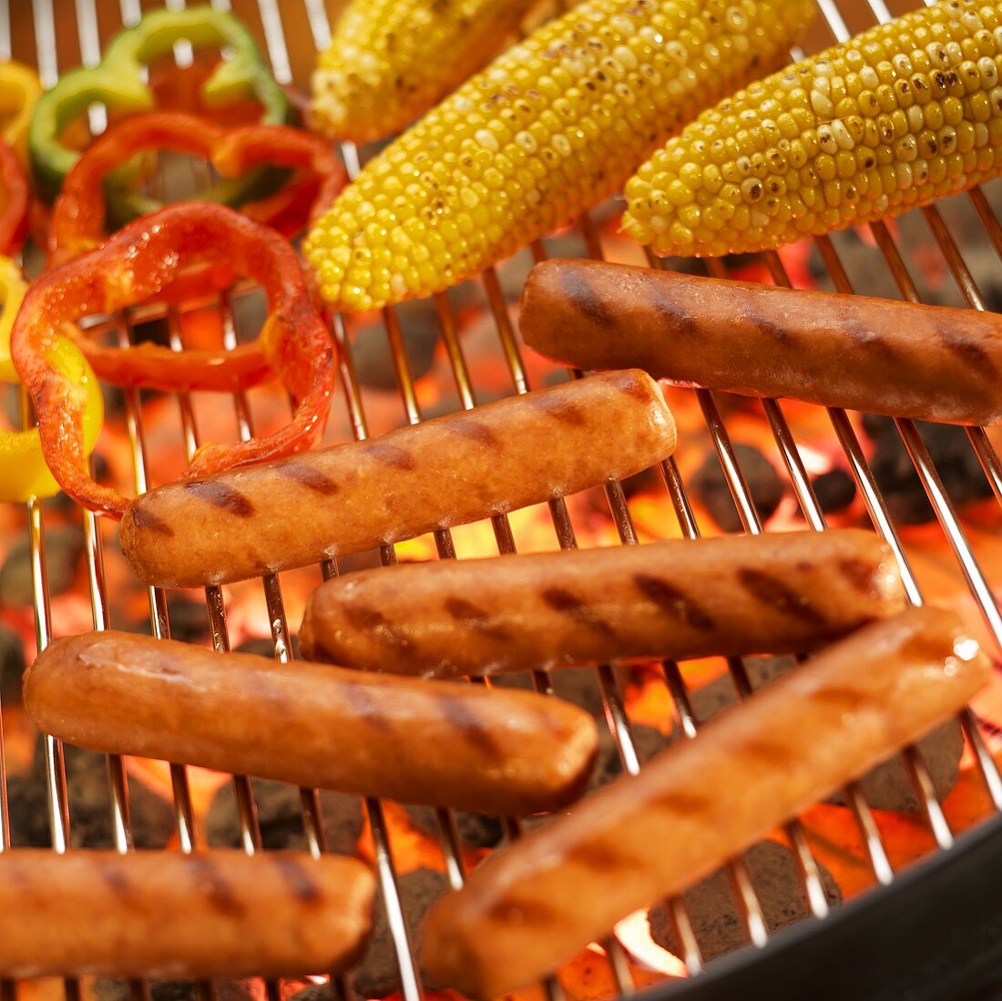 Hot Dogs, Corn Cobs and Peppers on Grill