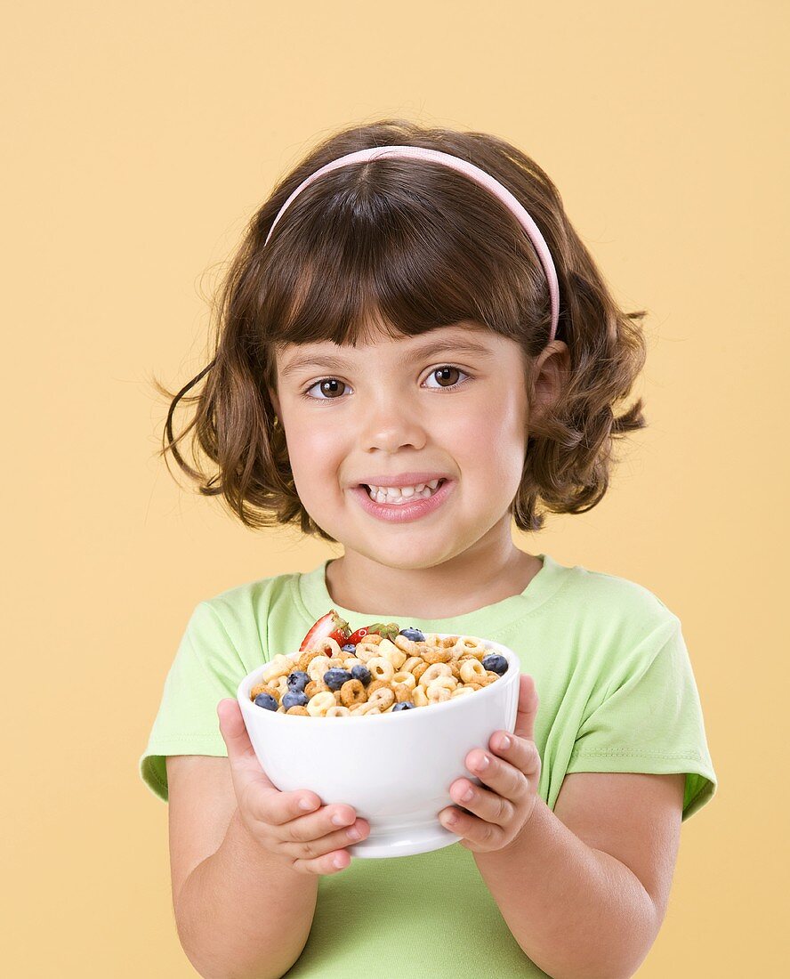 Little Girl Holding Bowl of Cereal with Fruit