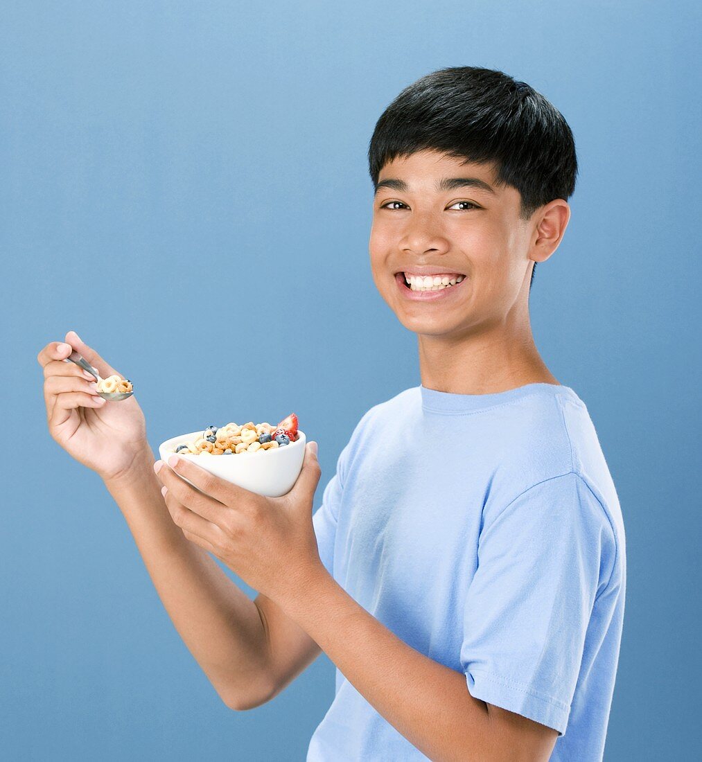 Boy Holding Bowl and Spoon of Cereal