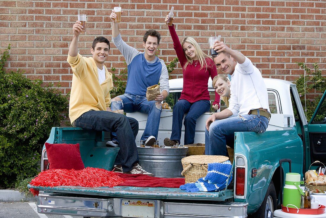 Friends Making a Toast at a Tailgating Party from the Back of a Pickup