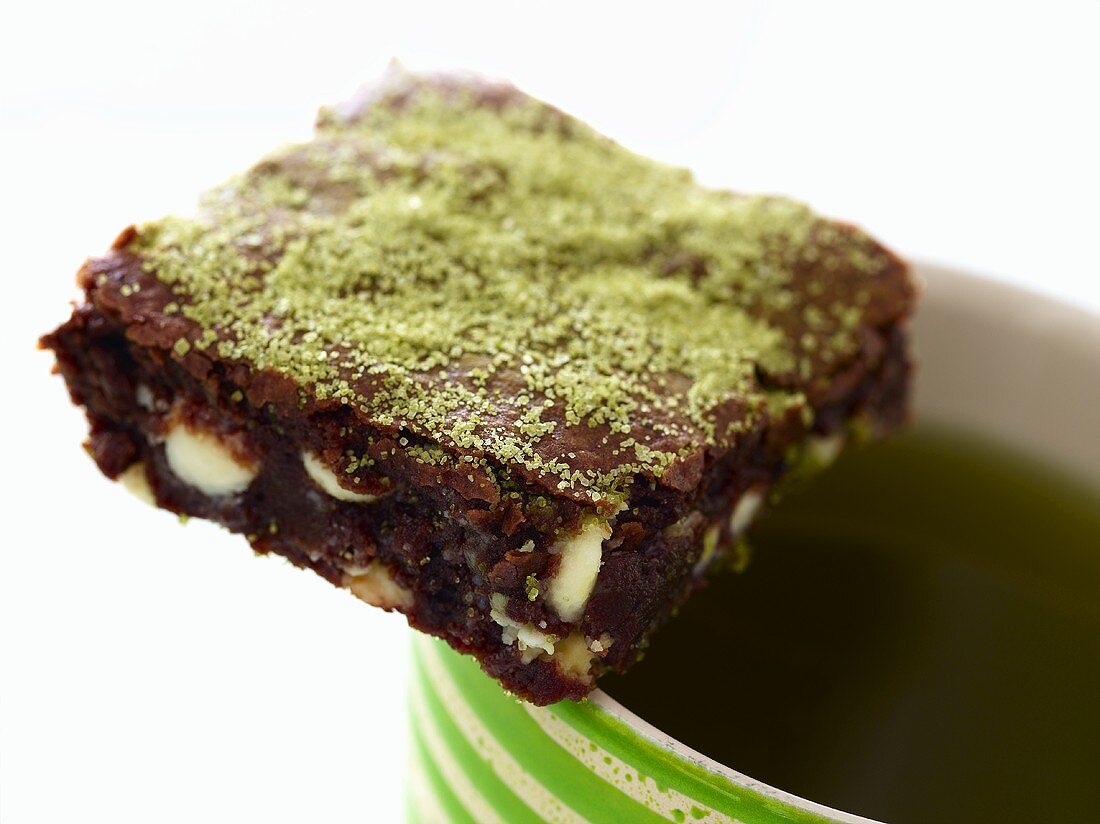 Pistachio Brownie on Rim of Coffee Cup