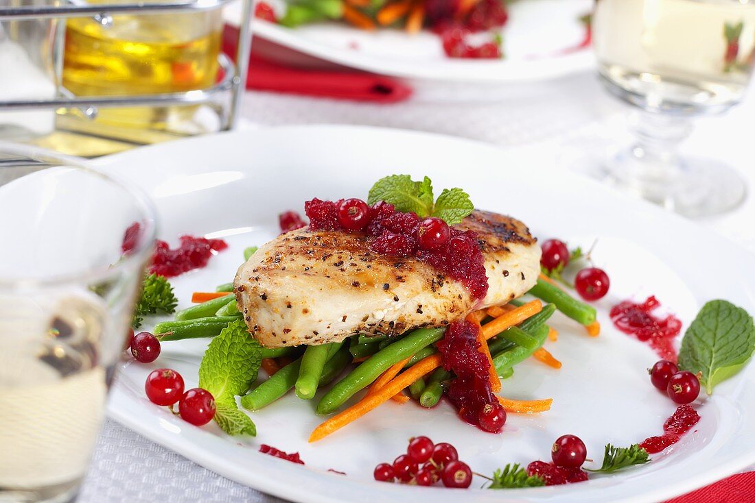 Grilled Chicken Breast on Steamed Vegetables with Red Currant Sauce
