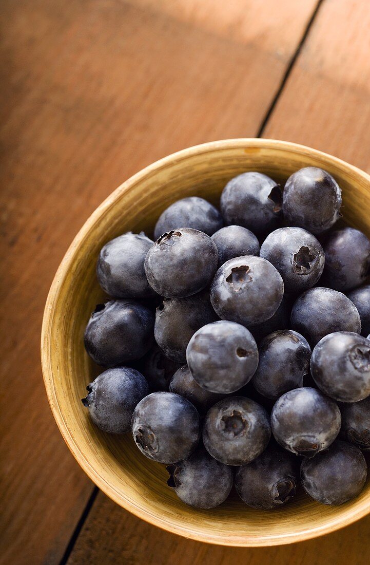 Small Bowl of Organic Blueberries on Wooden Table