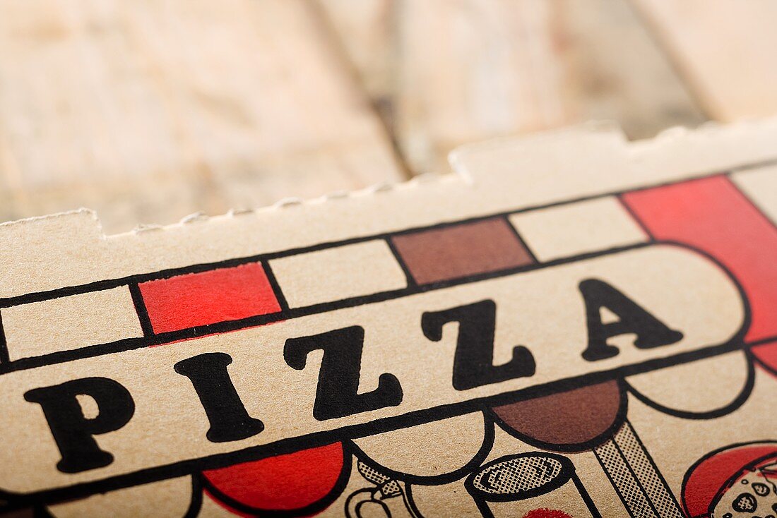Close Up of the Word Pizza on Pizza Take Out Box
