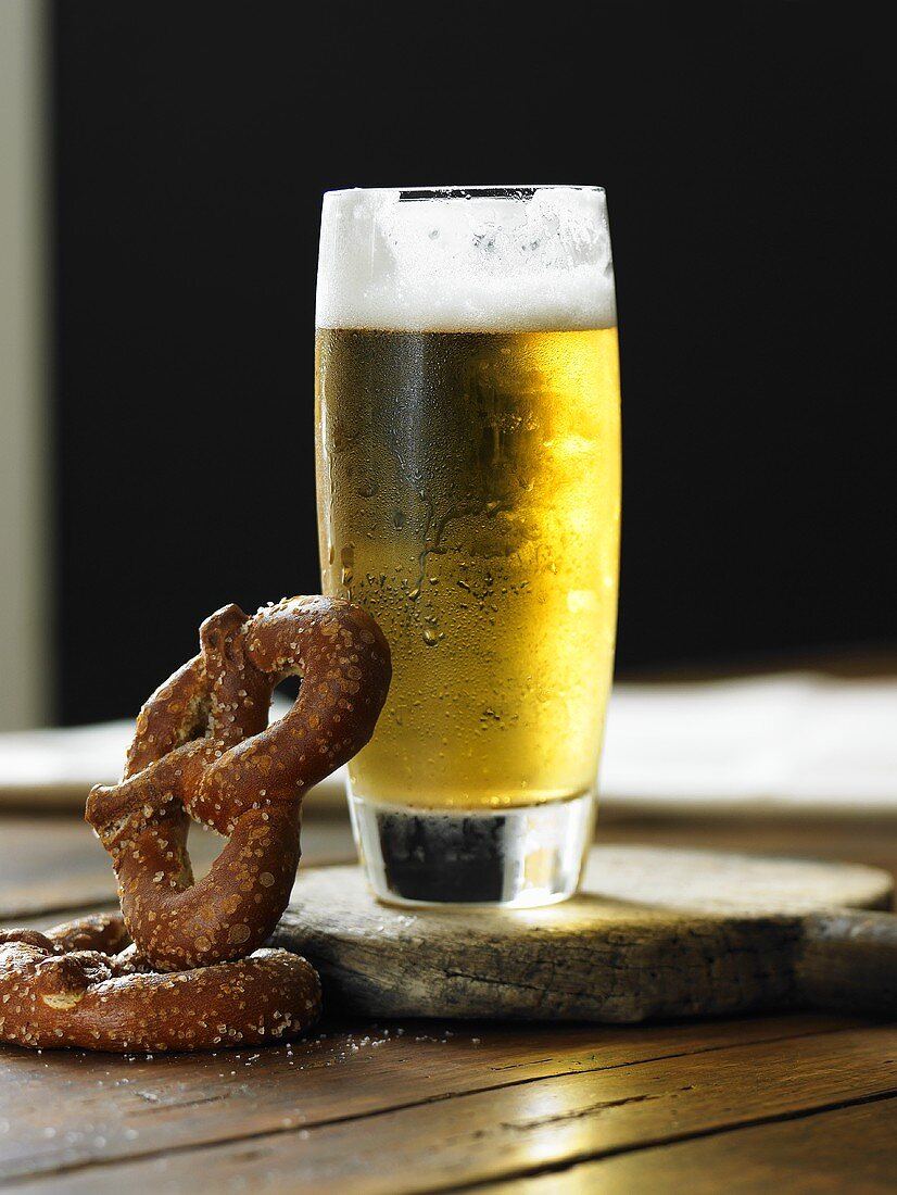 Cold Glass of Beer with Pretzels