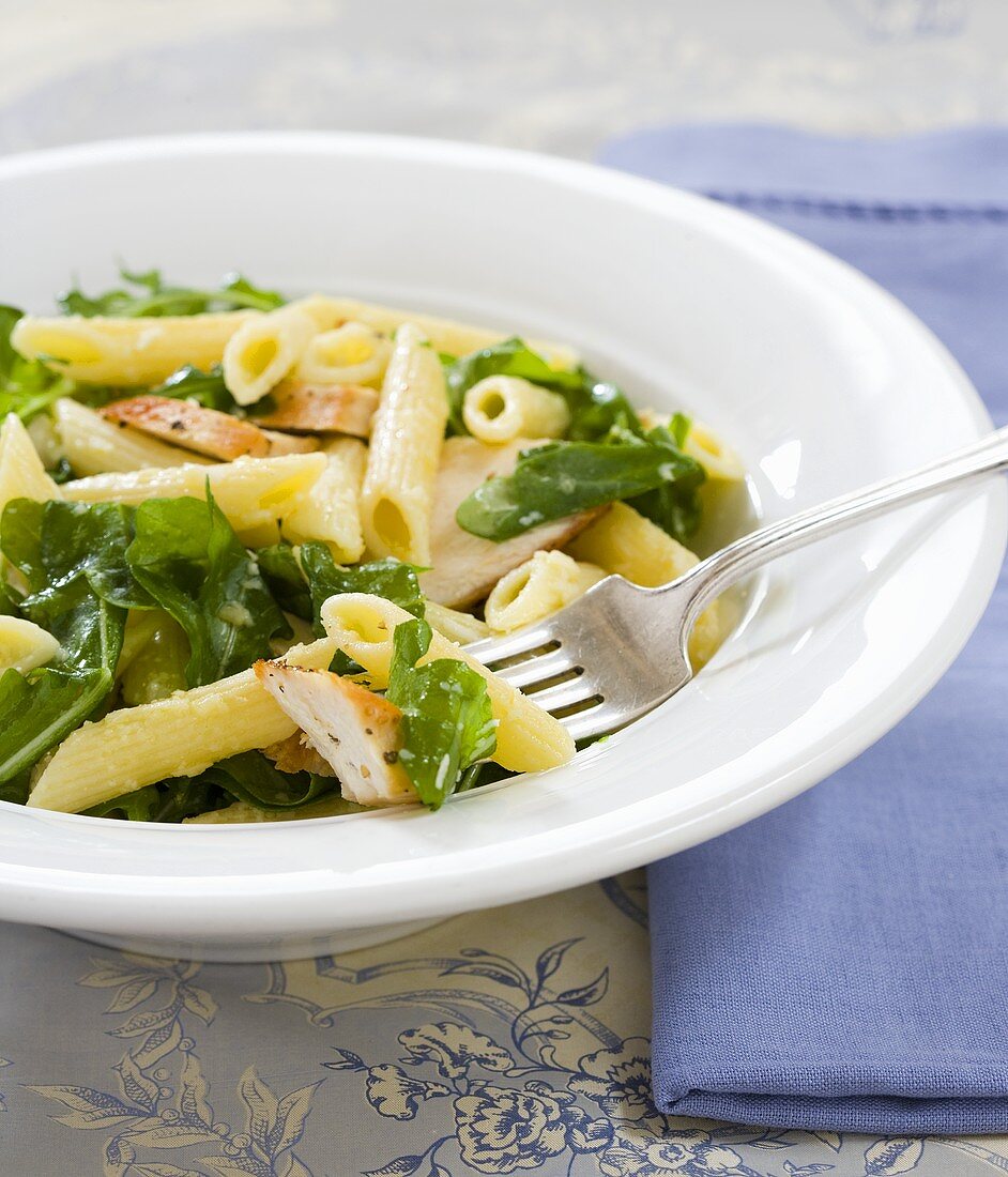 Penne Pasta with Chicken and Arugula in a Bowl