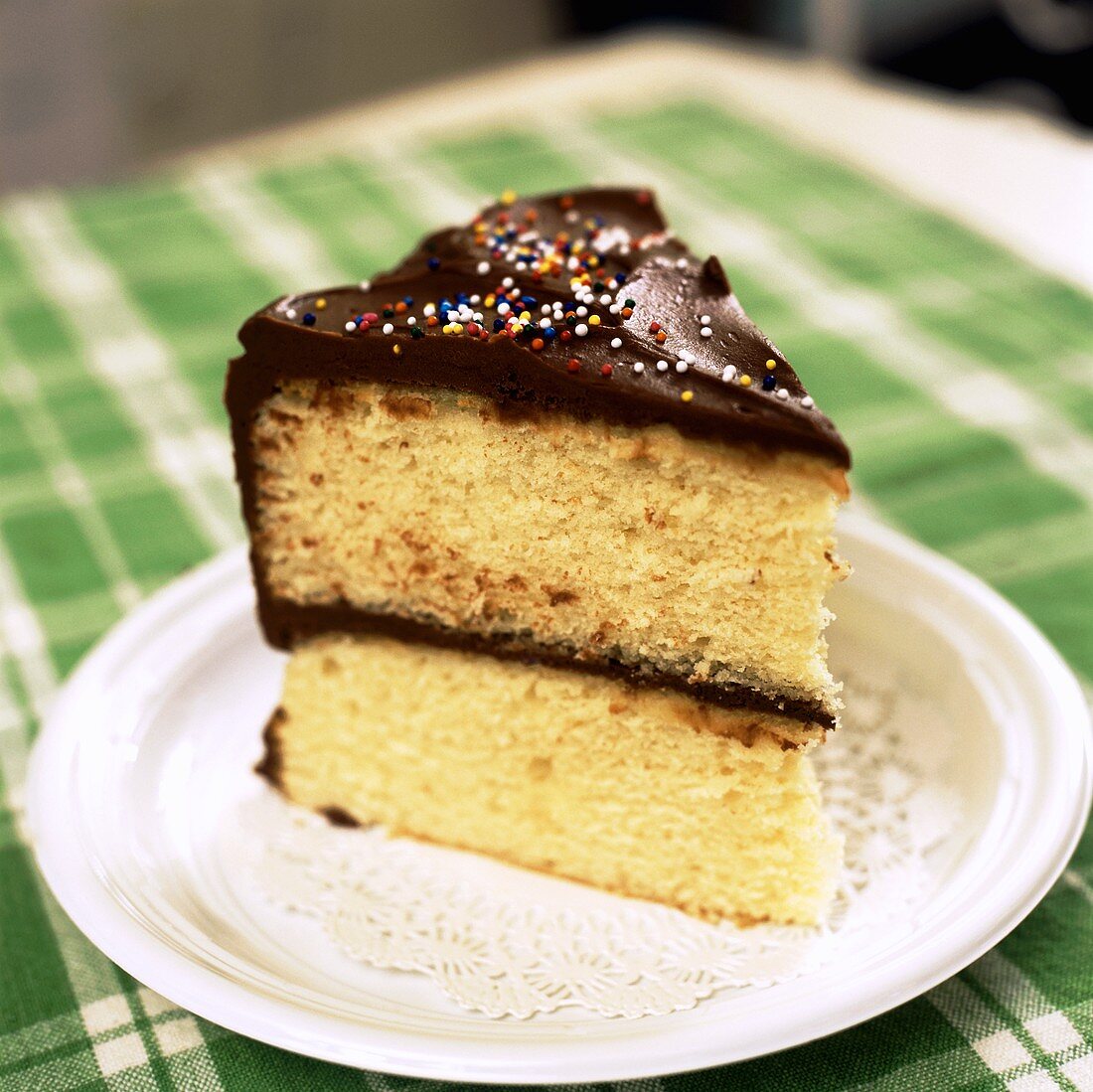 Slice of Yellow Cake with Chocolate Frosting with Sprinkles