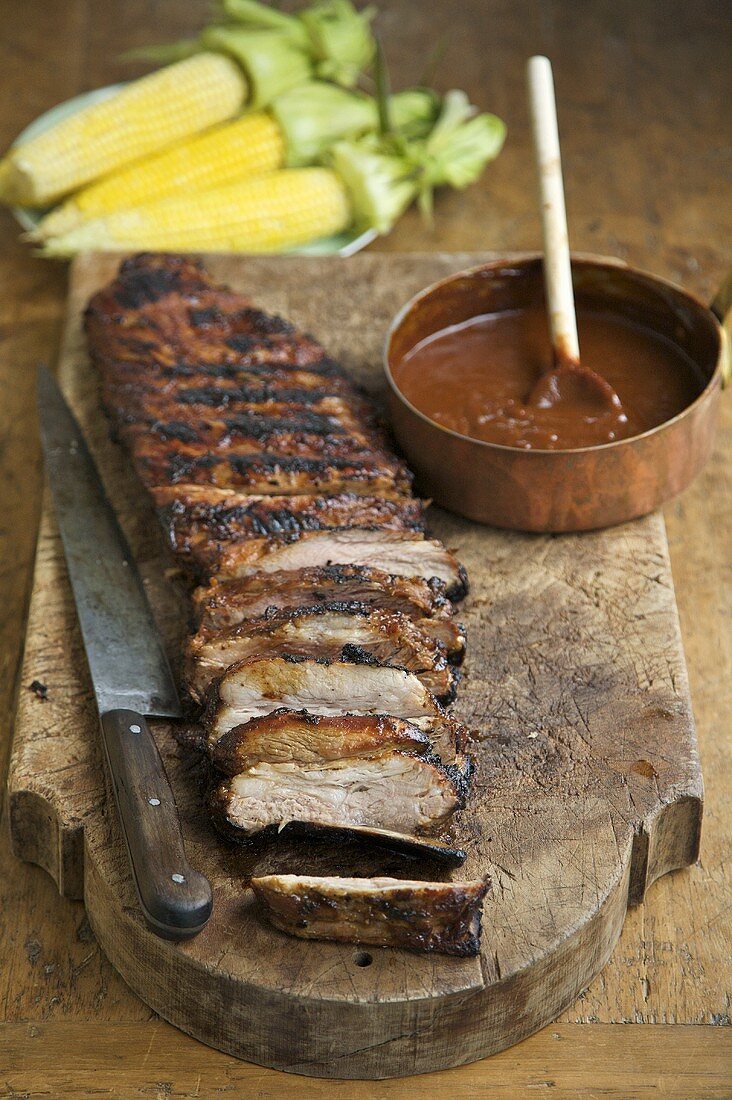 Sliced Barbecue Ribs on Cutting Board with Sauce