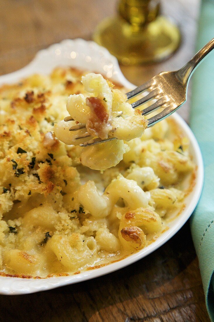 Forkful of Baked Organic Macaroni and Cheese Above Dish