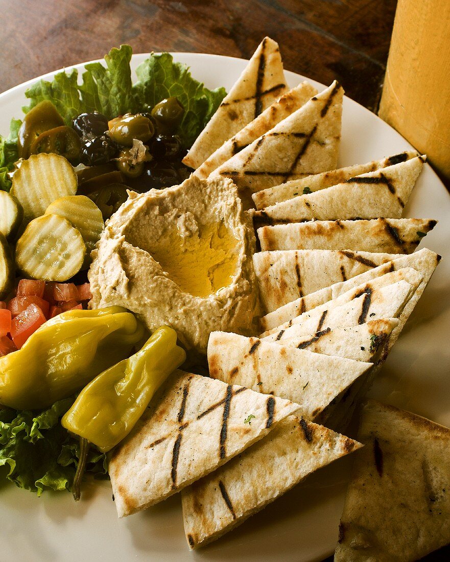 Hummus Platter with Grilled Pita Bread, Pickles and Olives