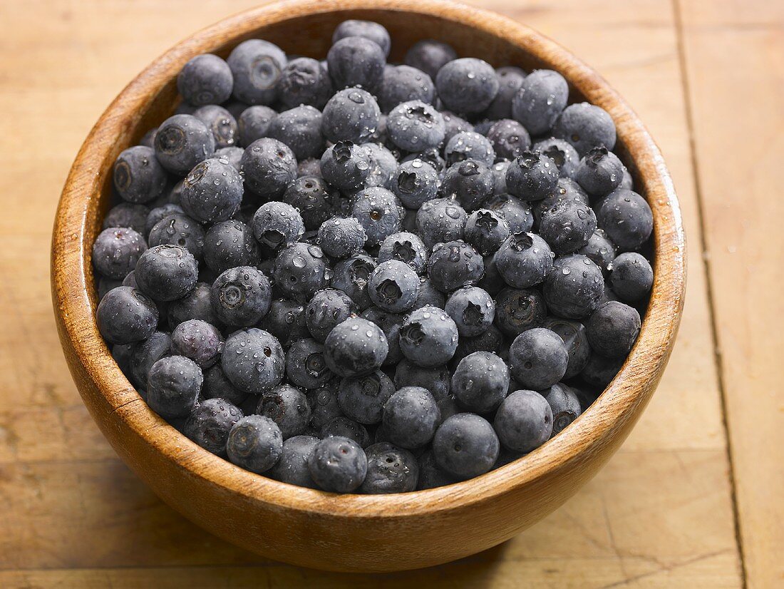 Wooden Bowl of Blueberries with Water Droplets 