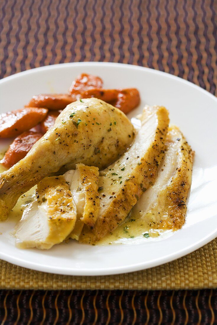 Sliced Roast Chicken on a Plate with Carrots 