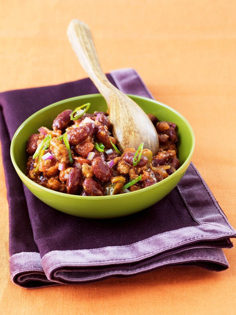 Bowl of Hearty Chili with Wooden Spoon