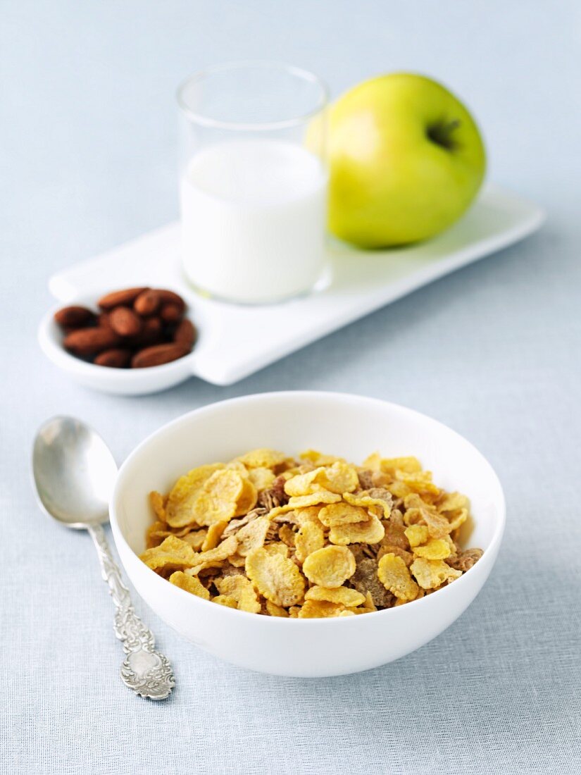 Bowl of Cold Cereal; Nuts, Milk and Apple