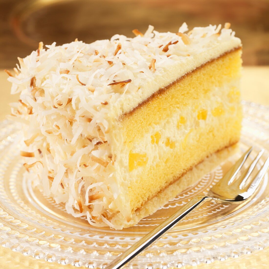 Slice of Pineapple Cream Cake with Toasted Coconut; Fork 