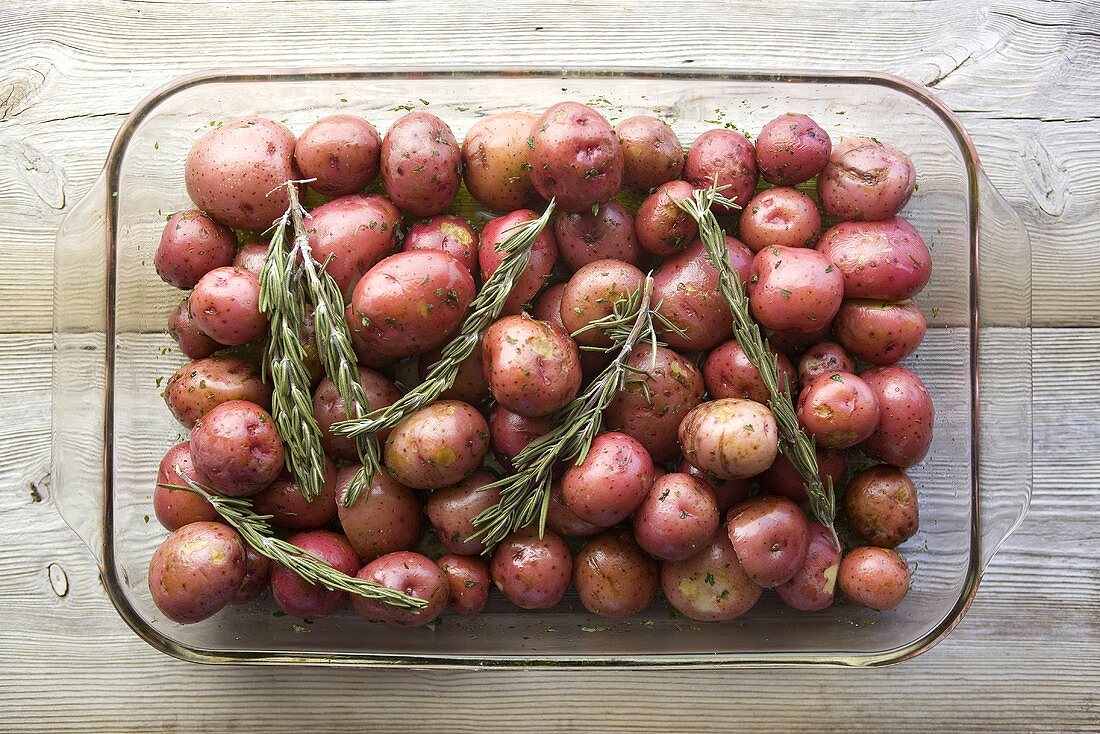 Red Potatoes and Rosemary Ready for Roasting in Glass Dish