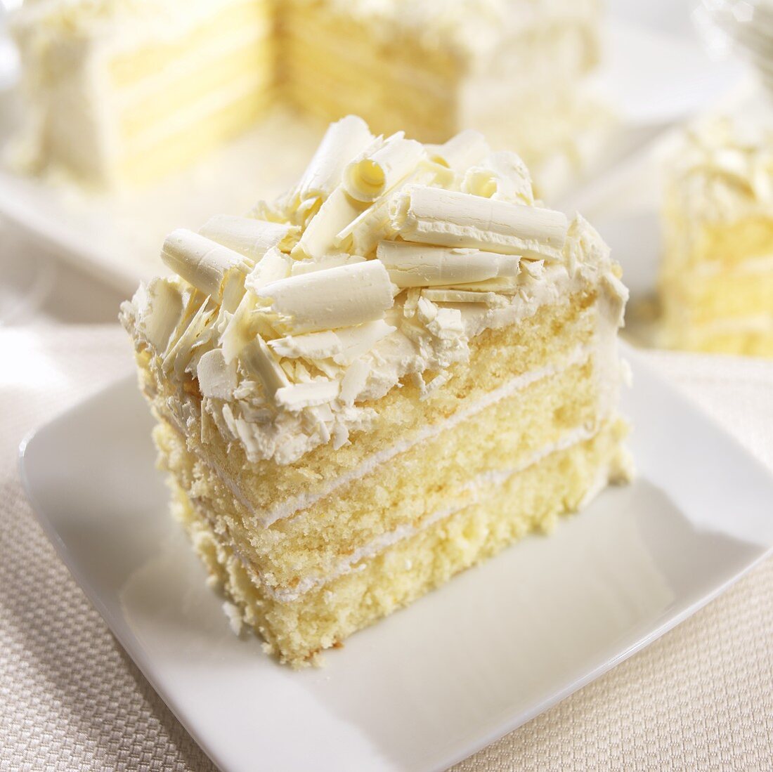 Slice of White Layer Cake with White Chocolate Curls