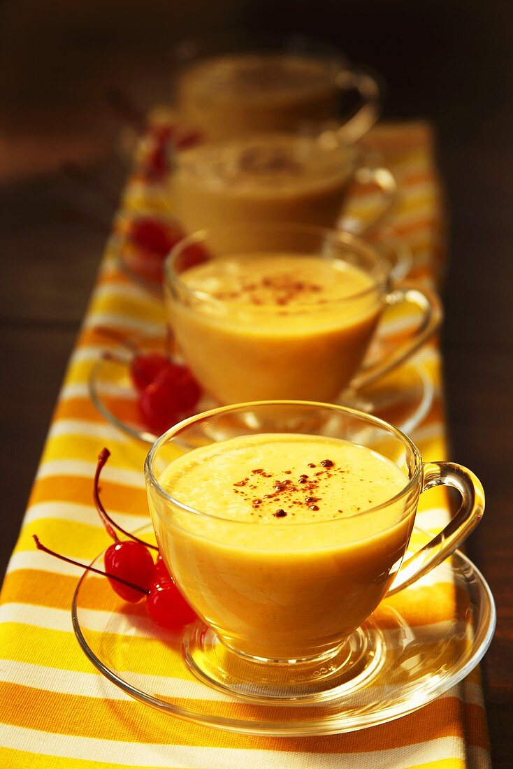 Cups of Mango Lassi with Cinnamon and Cherries