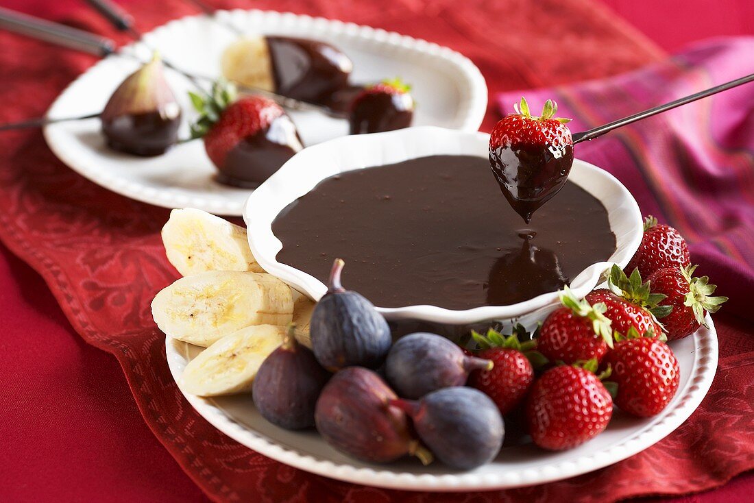 Strawberry Dipping into Chocolate Fondue 