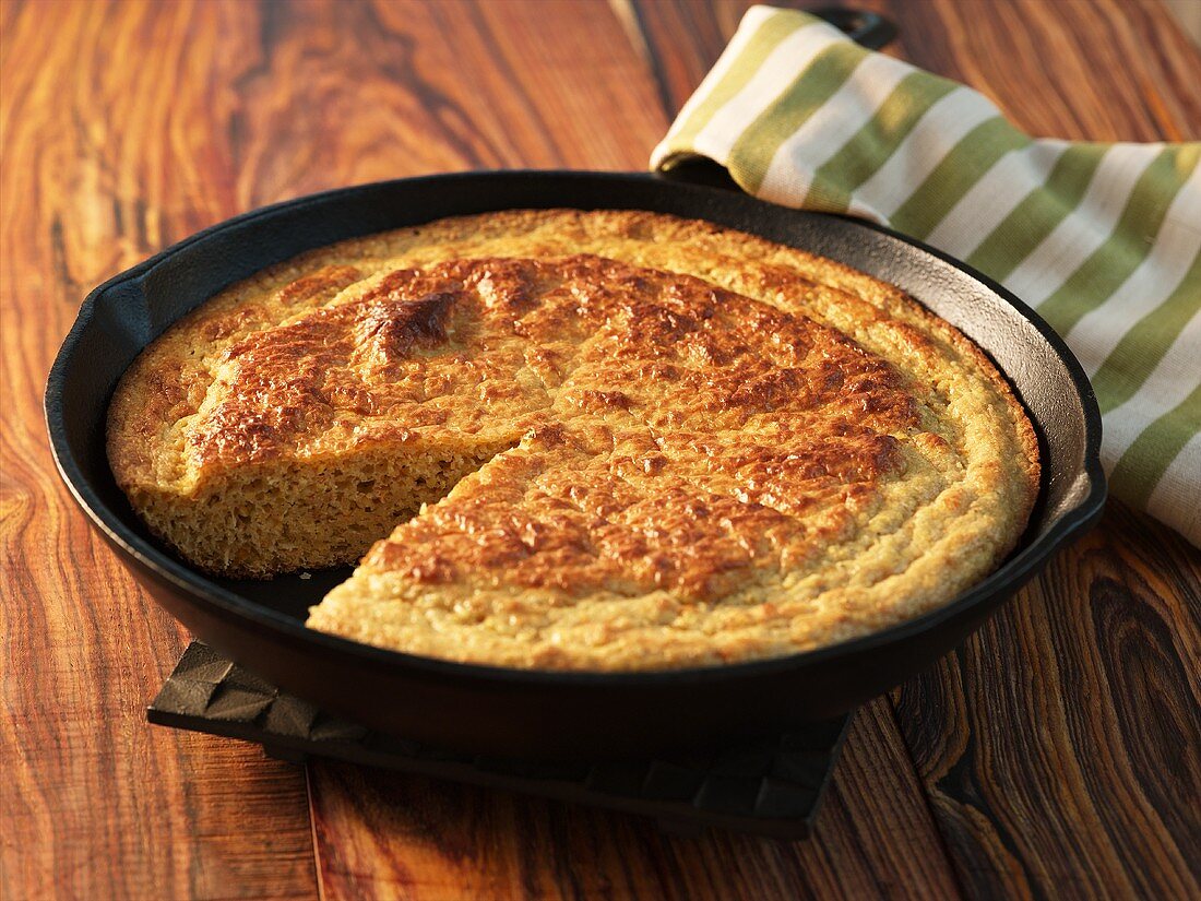Cornbread in Cast Iron Skillet with Slice Removed