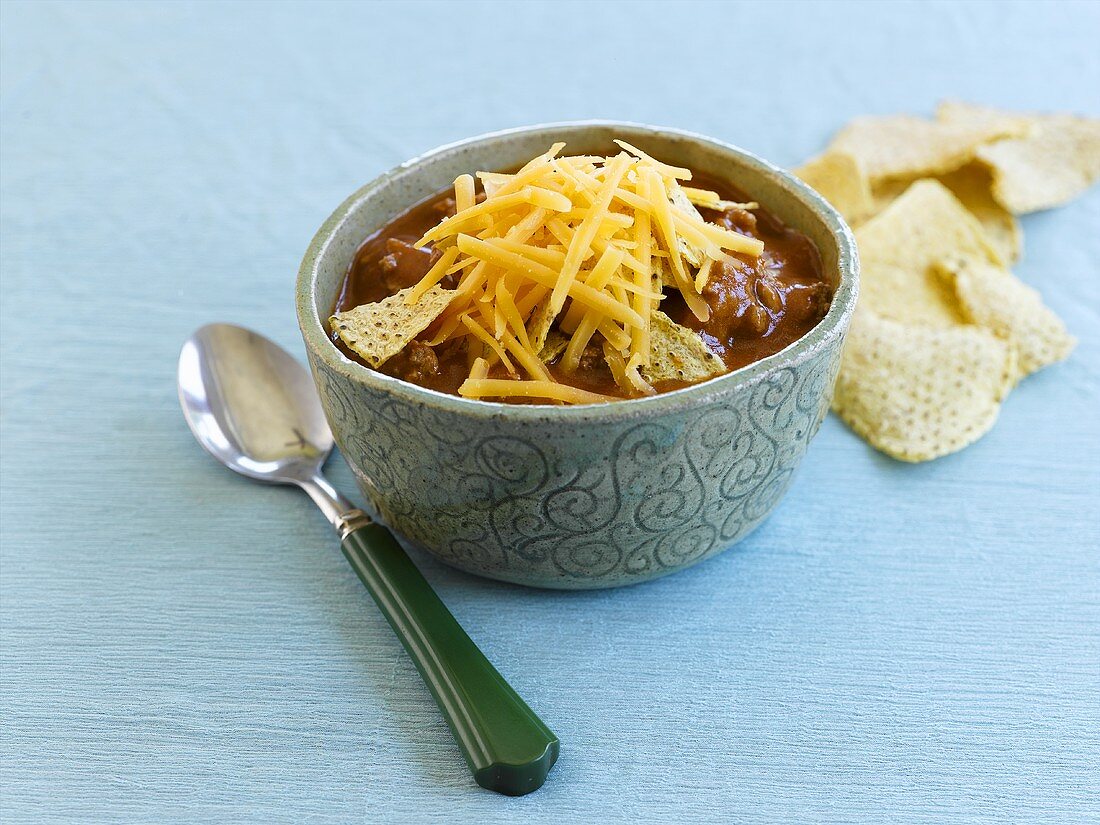 Bowl of Tomato Fiesta Soup with Shredded Cheese and Tortilla Chips