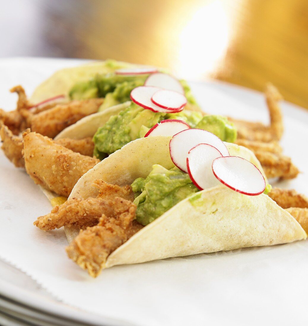 Tacos mit frittiertem Fisch, Guacamole und Radieschen