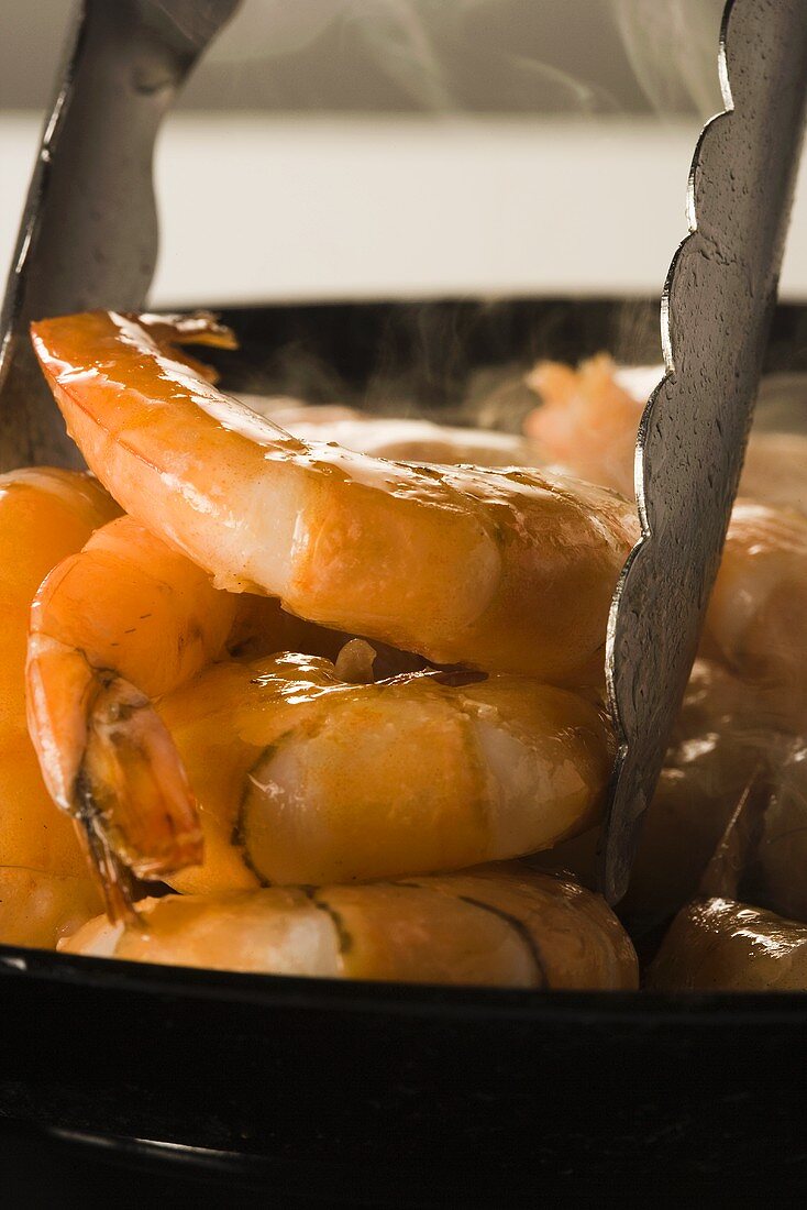 Shrimp Cooking in Frying Pan; Tongs