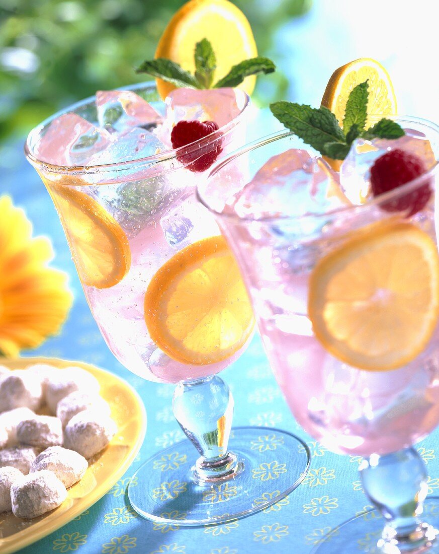 Pink Lemonade in Glasses with Mint and Raspberry Garnish