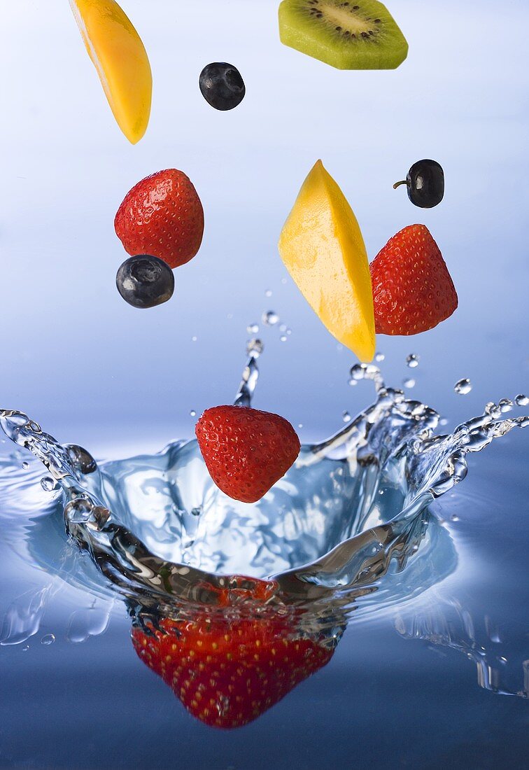 Frische Früchte fallen ins Wasser