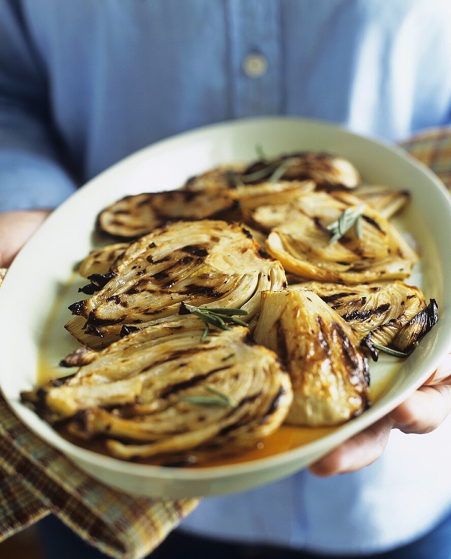 Person Holding Platter of Grilled Fennel