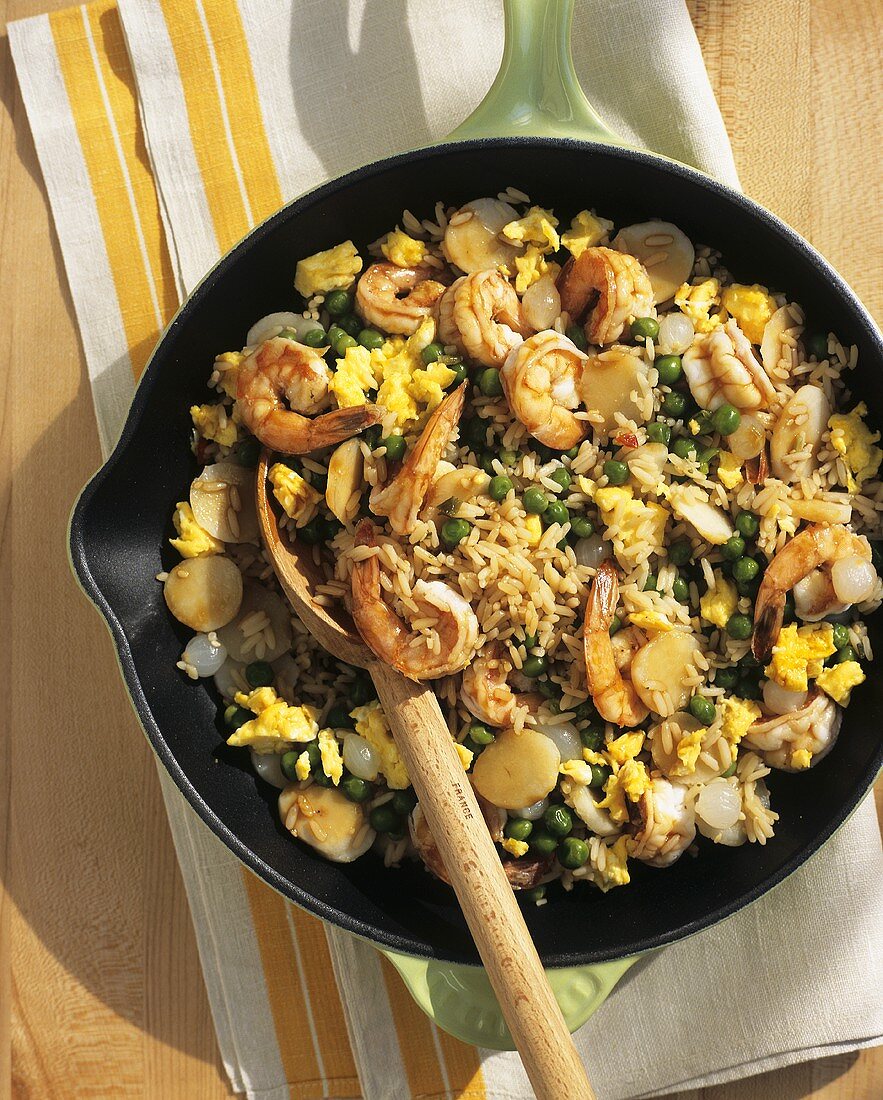 Seafood Paella in a Skillet with Wooden Spoon