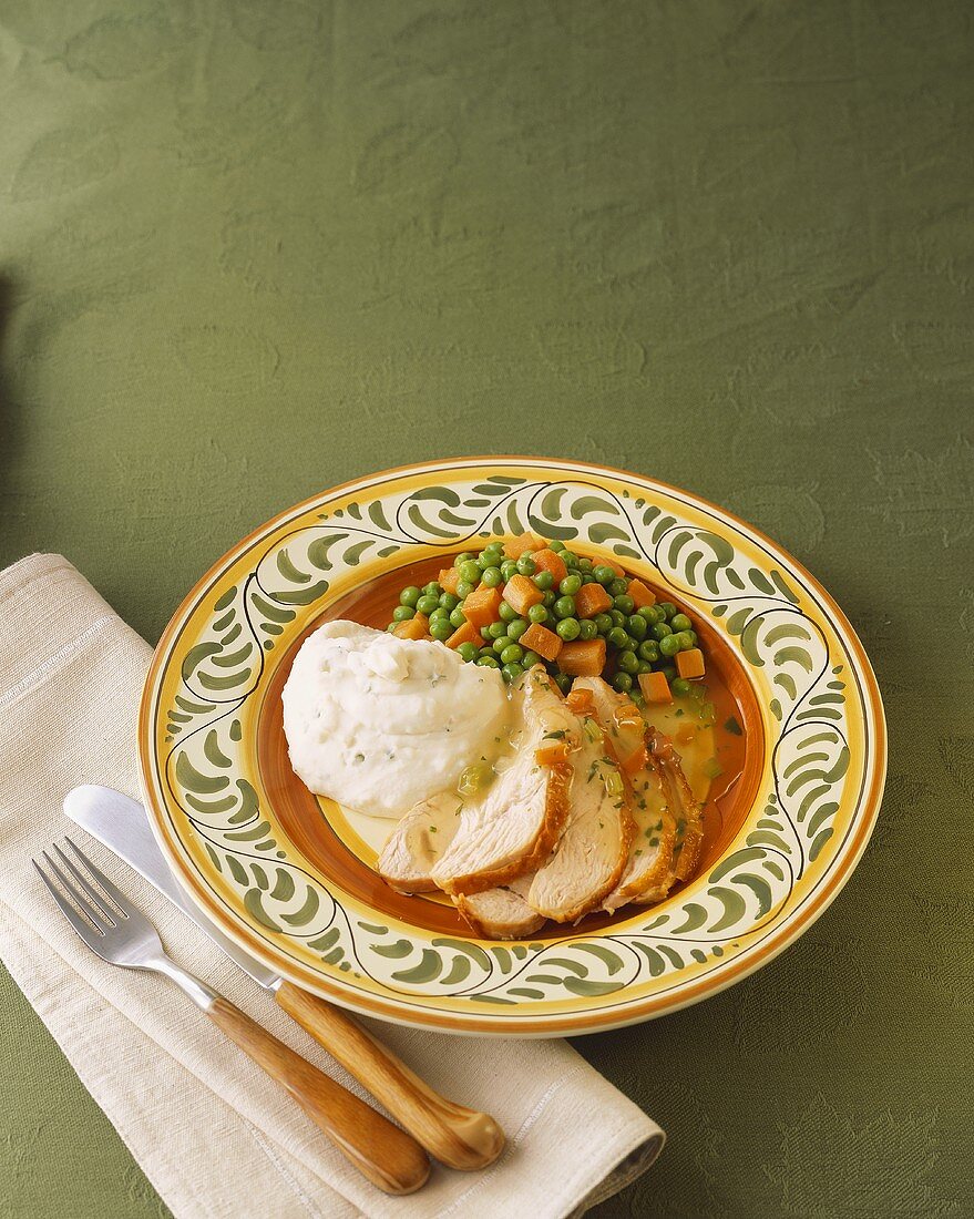 Sliced Turkey with Mashed Potatoes and Peas and Carrots