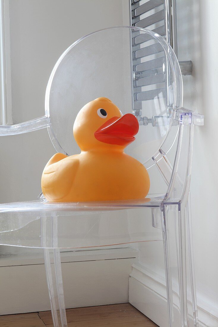 A giant rubber duck on a Philippe Starck chair