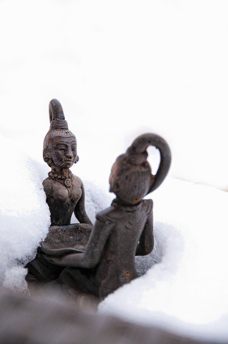 An oriental garden ornament in the snow