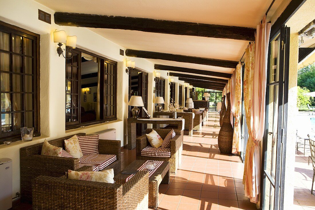 Covered terrace of a hotel with seating furniture