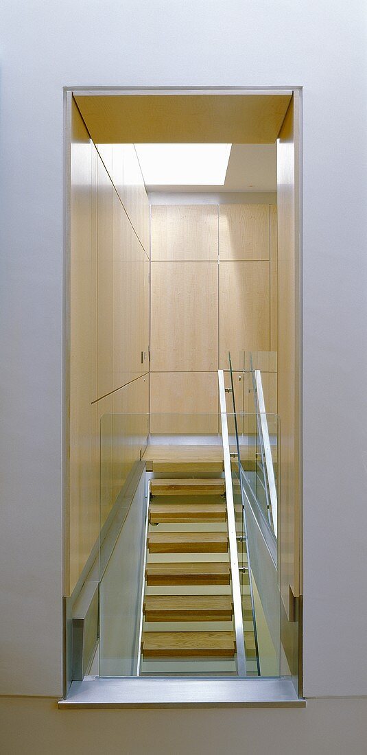 A view of modern stairway with built in wooden cupboards