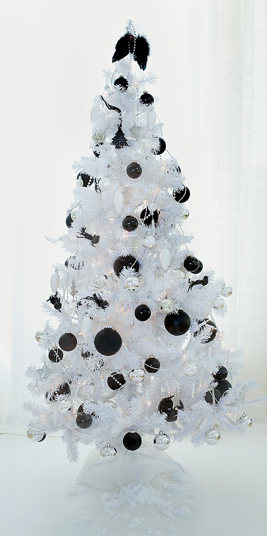 A white Christmas tree with black baubles