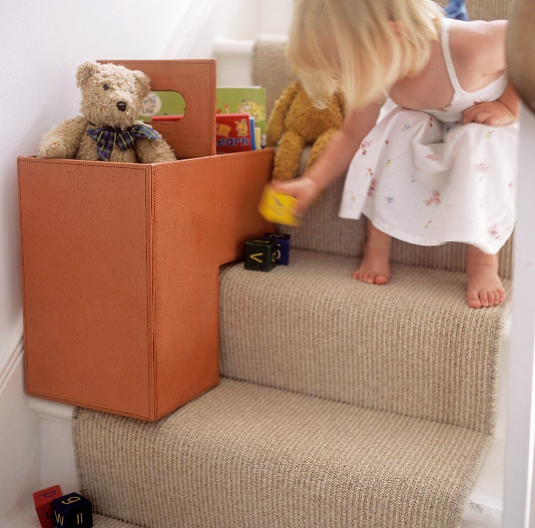 Little girl playing on the stairs