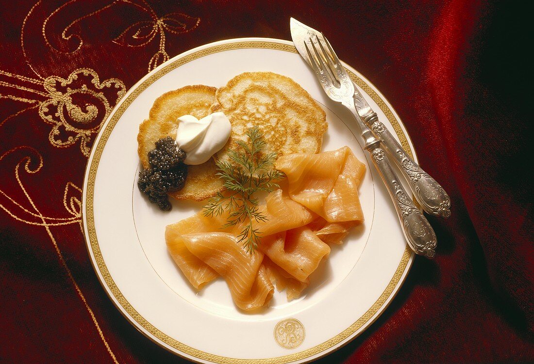 Salmon with caviare and blinis, with cutlery