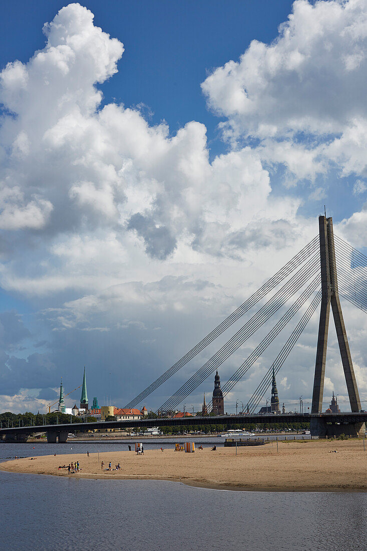 Badestrand in Kipsala unter der Vansu Tilts Bruecke, Fluss Daugava, hinten die Altstadt, Blick aus Kipsala, Riga, Lettland