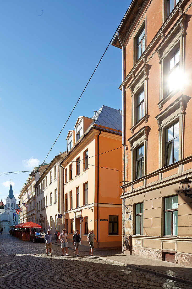 Tourists at Pils Iela, street off cathedral square, old town centre, Riga, Latvia