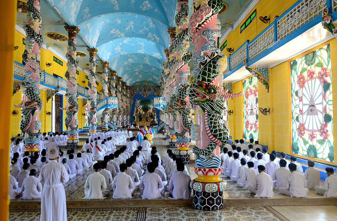 People praying in the cathedral of Tay Ninh, Vietnam, Asia