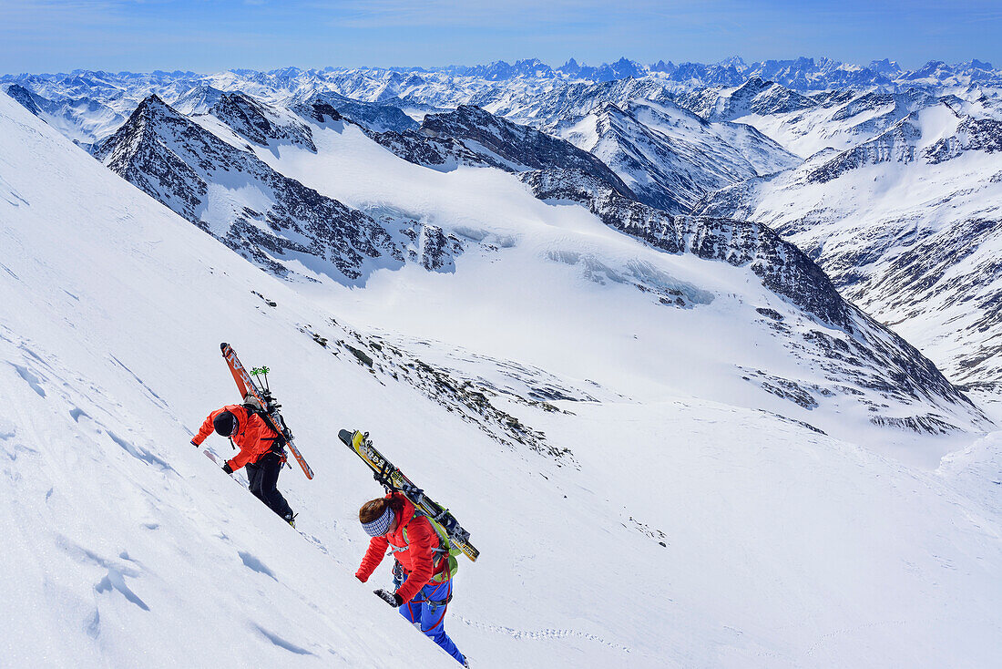 Two persons back-country skiing ascending with ice axe and crampons towards Dreiherrnspitze, Dreiherrnspitze, valley of Ahrntal, Hohe Tauern range, South Tyrol, Italy